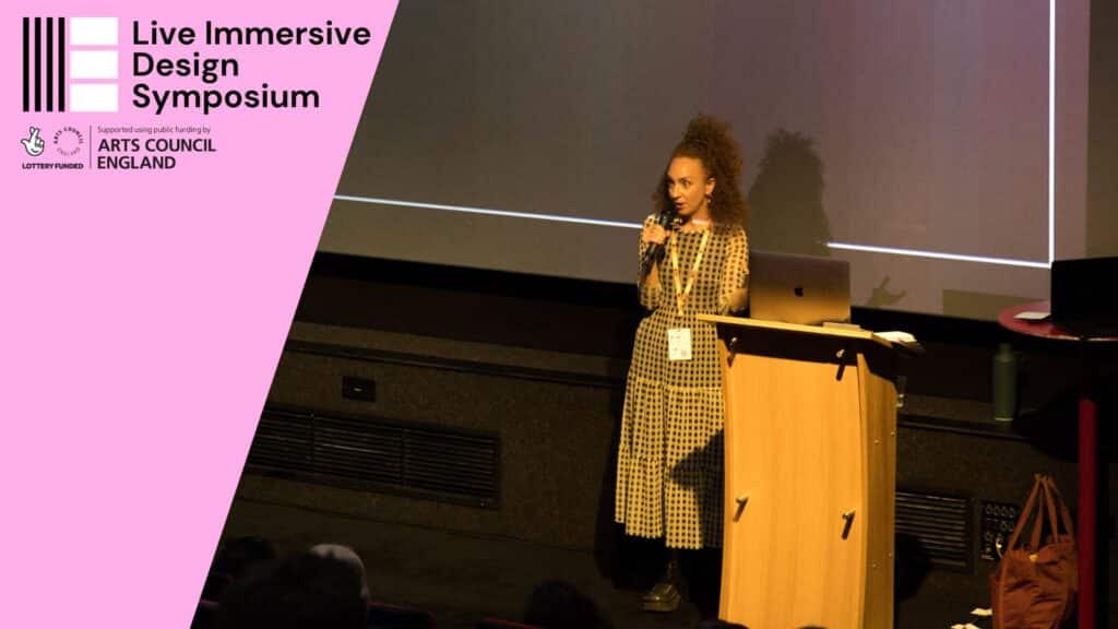 Photo of Robyn Landau presenting at the Live Immersive Design Symposium in October 2023