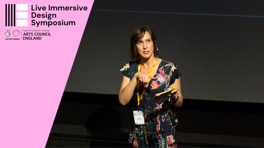 Photo of Sophie Larsmon presenting at the Live Immersive Design Symposium in October 2023