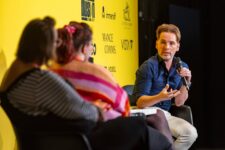 Panel discussion with blurred audience members